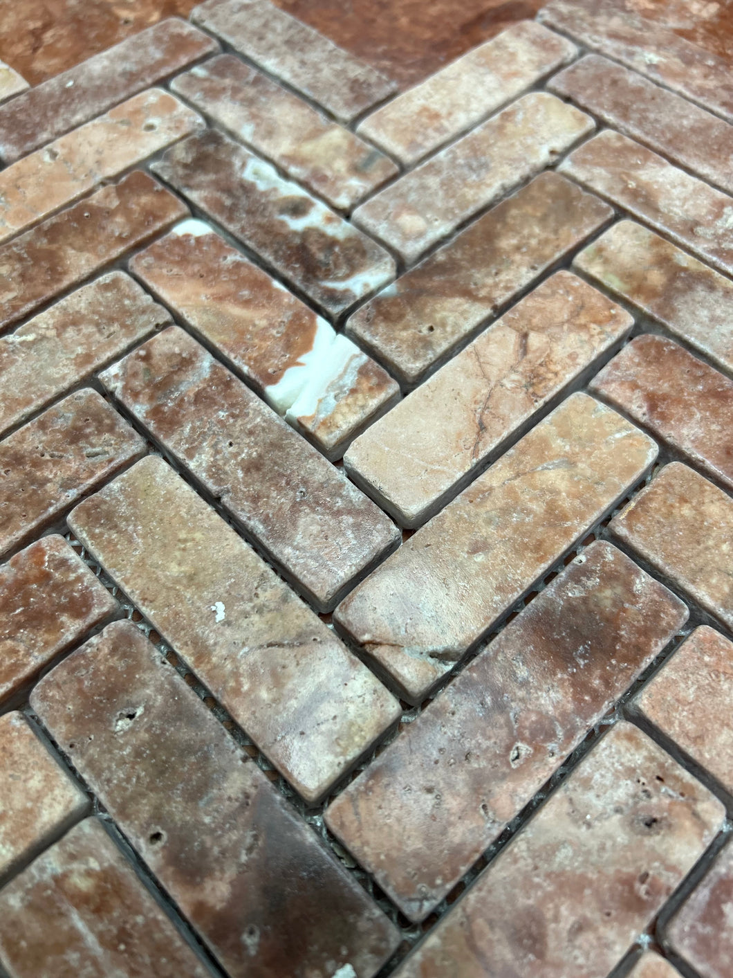 ROSSO TRAVERTINE HERRINGBONE UNFILLED & TUMBLED MOSAIC